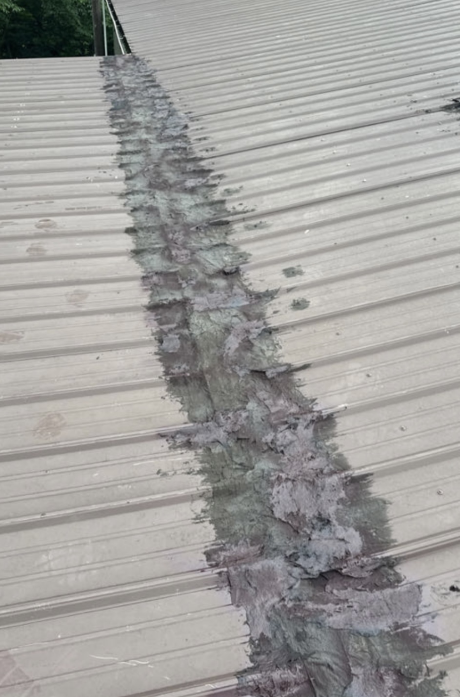 Excessive sealant along metal roof ridge